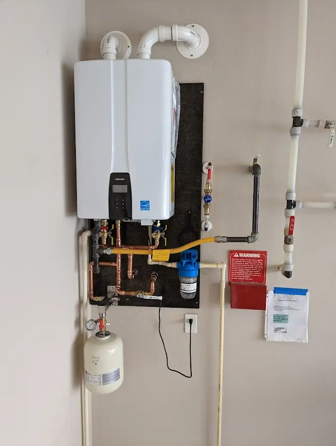 Professional plumber installing copper piping in a Lockhart home